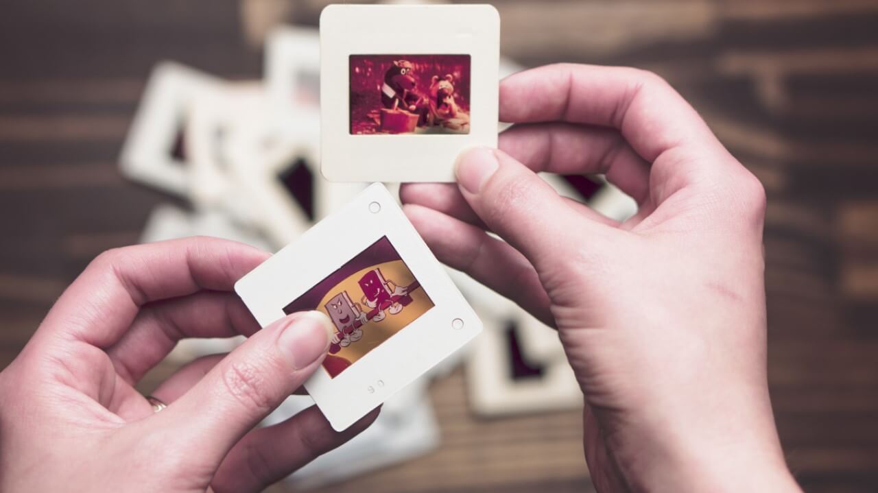 Woman's hands sorting slide projector photos | stock photos for marketing